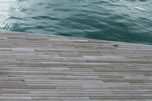 pool services timber decking next to swimming pool edge